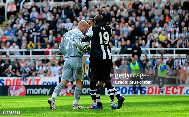Newcastle forward Demba Ba attempts to intervene as Liverpool keeper Pepe Reina allegedly head buts Newcastle defender James Perch during the...