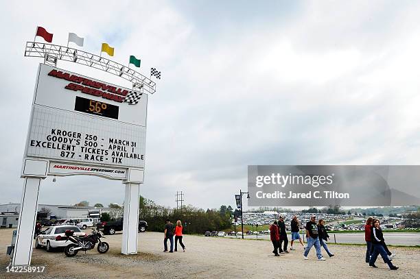 Race fans walk past the entrance sign for Martinsville Speedway prior to the NASCAR Sprint Cup Series Goody's Fast Relief 500 at on April 1, 2012 in...