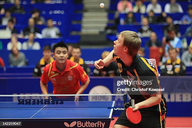 Patrick Baum of Germany serves during hsi match against Wang Hao of China during the LIEBHERR table tennis team world cup 2012 championship division...