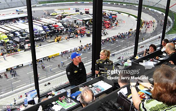 Clint Bowyer, driver of the 5-hour Energy Toyota, makes an appearance with Miss Sprint Kristen Beat prior to the NASCAR Sprint Cup Series Goody's...