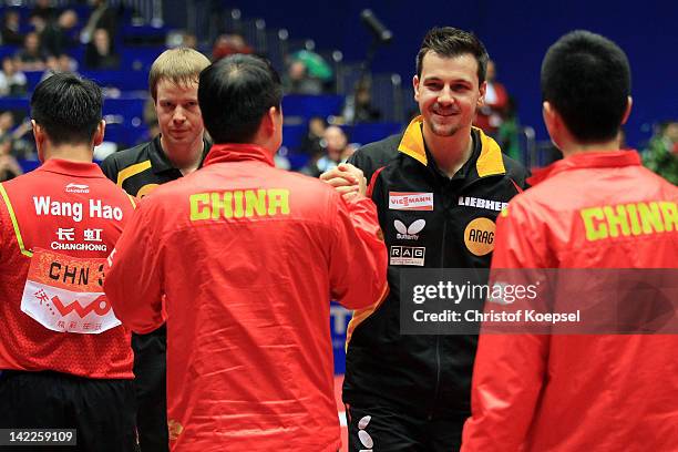 Timo Boll and Patrick Baum ger congratulate the chines team after the LIEBHERR table tennis team world cup 2012 championship division men's final...