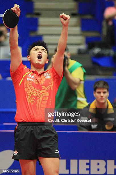 Wang Hao of China celebrates the 3-1 victory and winning the World Cup against Patrick Baum of Germany during the LIEBHERR table tennis team world...