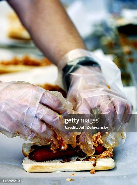 Martinsville Slider hot dog gets a topping of barbeque slaw in a concession stand during the NASCAR Sprint Cup Series Goody's Fast Relief 500 at...