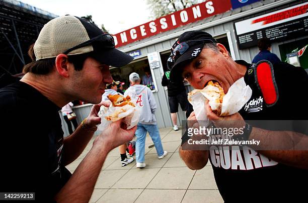 Jason and Marty Black eat Martinsville Slider hot dogs prior to the NASCAR Sprint Cup Series Goody's Fast Relief 500 at Martinsville Speedway on...