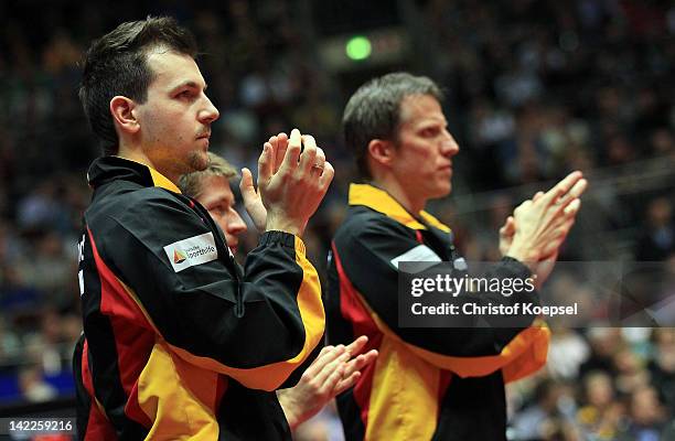 Timo Boll, Bastian Steger and coach Joer Rosskopf of Germany look dejected during the LIEBHERR table tennis team world cup 2012 championship division...