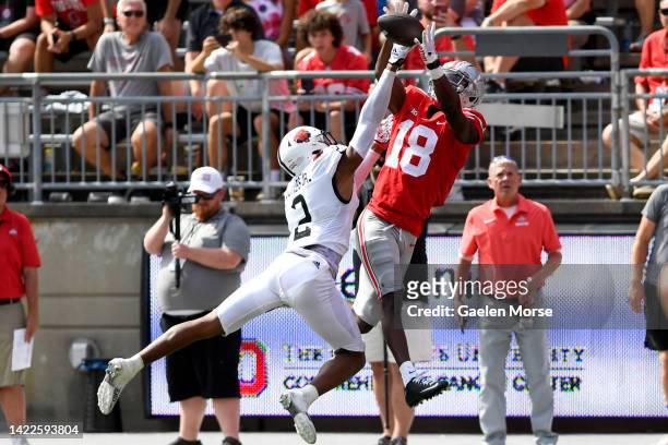 Wide receiver Marvin Harrison Jr. #18 of the Ohio State Buckeyes catches a touchdown pass over cornerback Leon Jones of the Arkansas State Red Wolves...