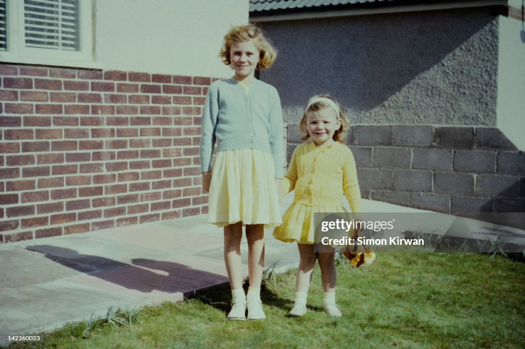 Sisters standing in garden