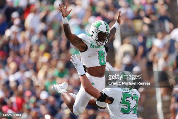 Khalan Laborn of the Marshall Thundering Herd celebrates a touchdown with Ethan Driskell against the Notre Dame Fighting Irish during the first half...