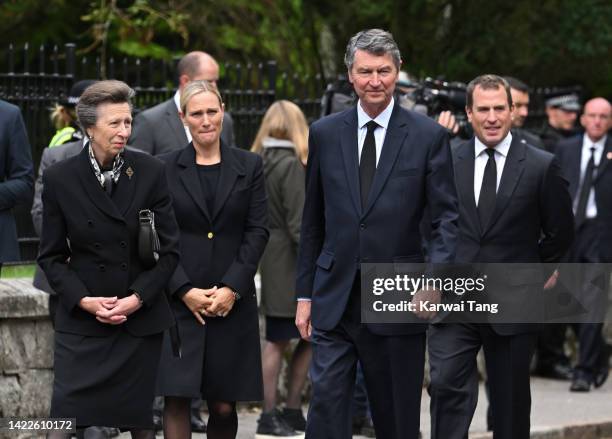 Anne, Princess Royal, Zara Phillip, Timothy Laurence and Peter Phillips view the flowers left by mourners outside Balmoral Castle on September 10,...