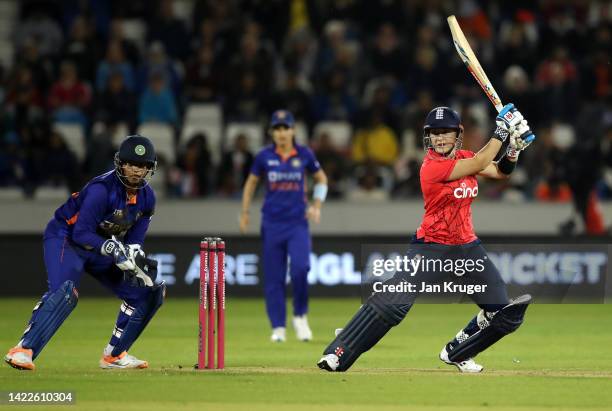 Alice Capsey of England bats with Richa Ghosh of India looking on during the 1st Vitality IT20 match between England Women v India Women at Seat...