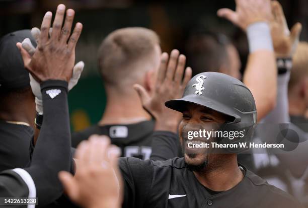 Elvis Andrus of the Chicago White Sox is congratulated by teammates after he hit a three-run home run against the Oakland Athletics in the top of the...