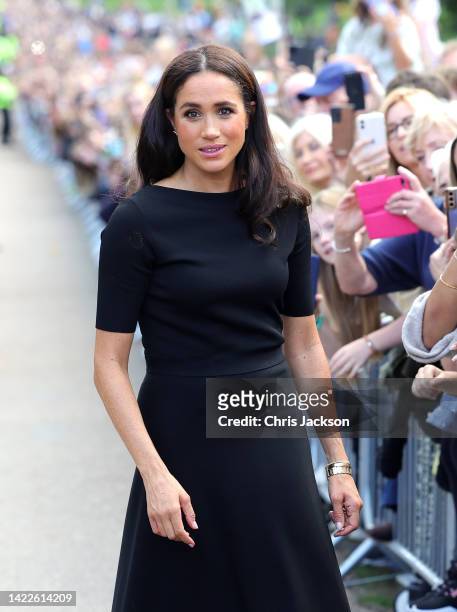 Meghan, Duchess of Sussex meets members of the public on the long Walk at Windsor Castle after viewing flowers and tributes to HM Queen Elizabeth on...
