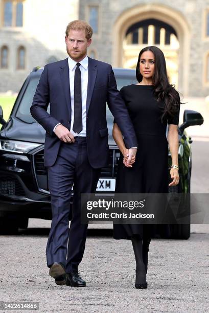 Prince Harry, Duke of Sussex, and Meghan, Duchess of Sussex on the long Walk at Windsor Castle arrive to view flowers and tributes to HM Queen...