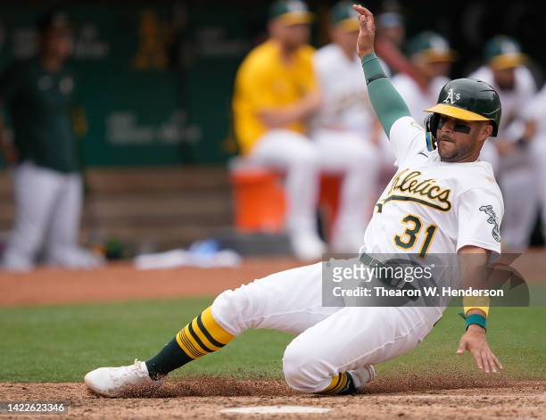 Vimael Machin of the Oakland Athletics scores on a sacrifice fly from Stephen Vogt against the Chicago White Sox in the bottom of the fourth inning...