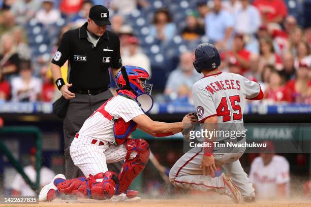 Garrett Stubbs of the Philadelphia Phillies tags Joey Meneses of the Washington Nationals during the first inning at Citizens Bank Park on September...