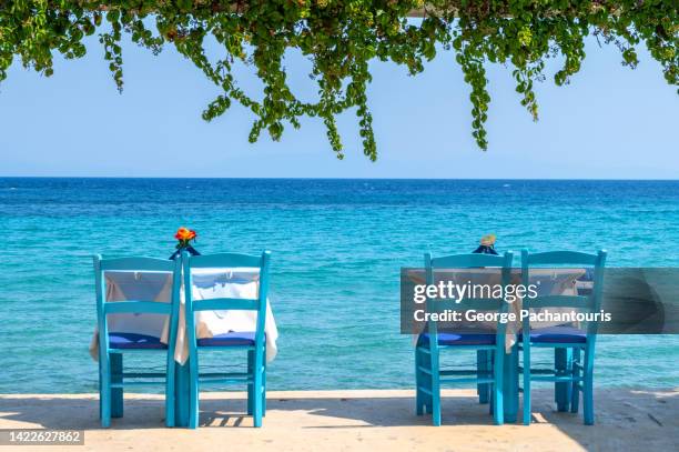 dining tables next to the sea - north aegean greece stock pictures, royalty-free photos & images