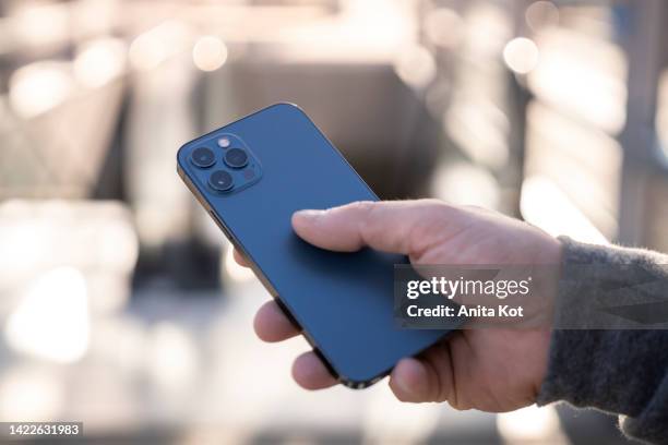 smartphone in male hand - photo messaging stock pictures, royalty-free photos & images