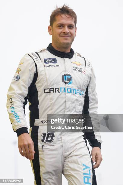 Landon Cassill, driver of the Carnomaly Chevrolet, walks onstage during driver intros prior to the NASCAR Xfinity Series Kansas Lottery 300 at Kansas...