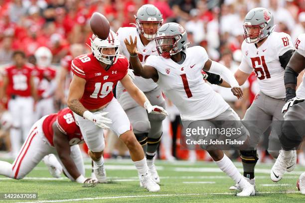 Cameron Ward of the Washington State Cougars flips the ball to a runner third quarter against the Wisconsin Badgers at Camp Randall Stadium on...