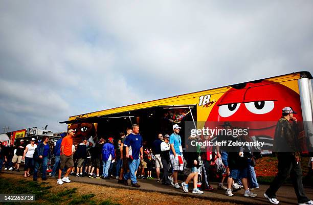 Fans line up outside the merchandise trailer of Kyle Busch, driver of the M&M's Toyota, prior to the NASCAR Sprint Cup Series Goody's Fast Relief 500...