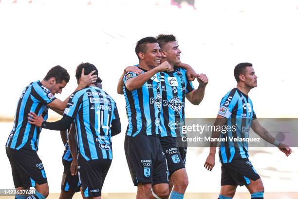 Ettson Ayon of Querétaro celebrates with his teammates after scoring his team's third goal during the 14th round match between Queretaro and Santos...