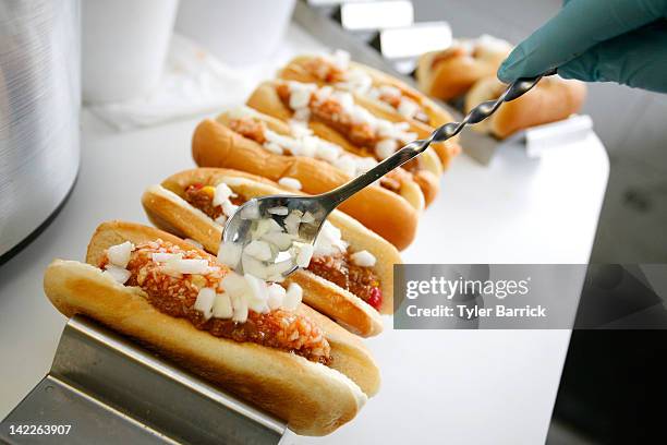 Martinsville Slider hot dogs are prepared in a concession stand prior to the start of the NASCAR Sprint Cup Series Goody's Fast Relief 500 at...