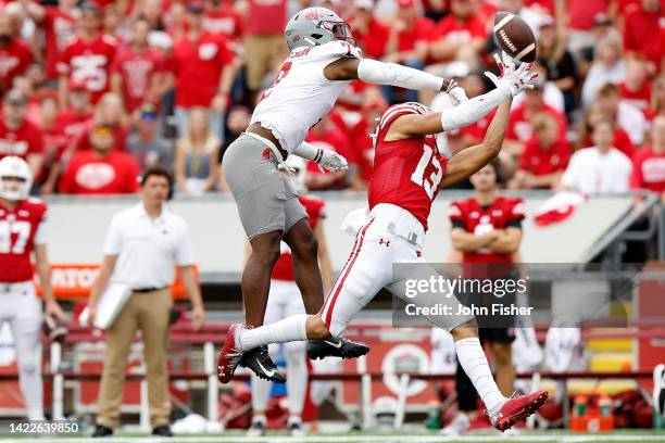 Chris Jackson of the Washington State Cougars defends Chimere Dike of the Wisconsin Badgers on a pass down field in the second quarter against the...