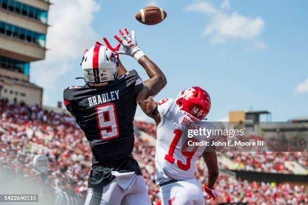 Defensive back Alex Hogan of the Houston Cougars breaks up a pass intended for wide receiver Jerand Bradley or the Texas Tech Red Raiders during the...