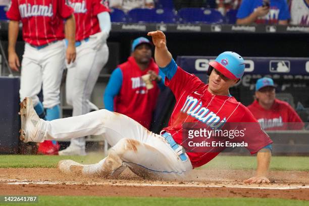 Joey Wendle of the Miami Marlins slides safely into home plate during the first inning against the New York Mets at loanDepot park on September 10,...