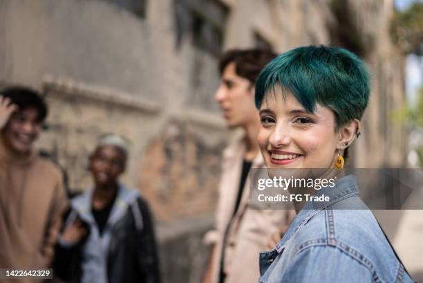 portrait of a young woman in the street with friends - green hair stock pictures, royalty-free photos & images