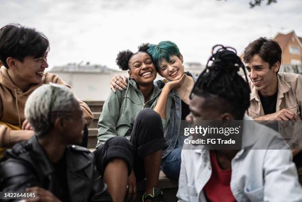friends talking in the street - human gender stock pictures, royalty-free photos & images