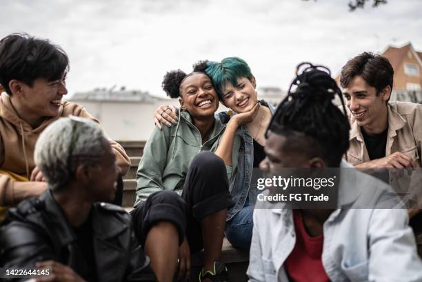 friends talking in the street - gender stock pictures, royalty-free photos & images