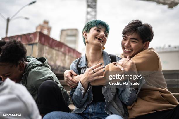 friends talking in the street - alternative lifestyle stock pictures, royalty-free photos & images