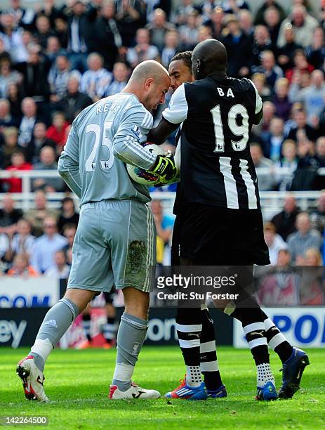 Newcastle forward Demba Ba attempts to intervene as goalkeeper Pepe Reina of Liverpool allegedly head butts James Perch of Newcastle during the...