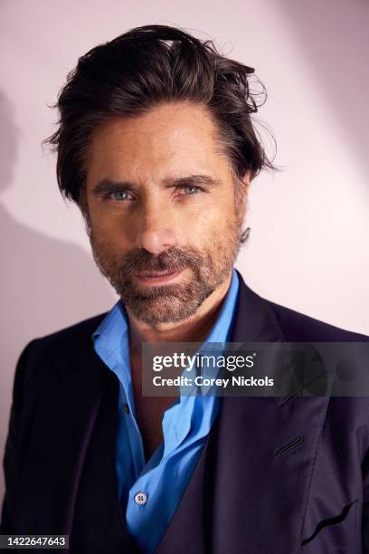 John Stamos poses at the IMDb Official Portrait Studio during D23 2022 at Anaheim Convention Center on September 10, 2022 in Anaheim, California.