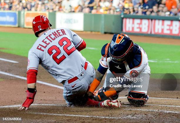 David Fletcher of the Los Angeles Angels is tagged out by Martin Maldonado of the Houston Astros in the first inning at Minute Maid Park on September...