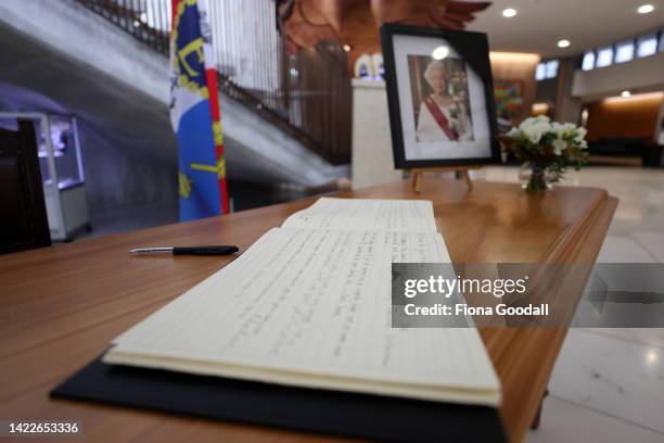 People sign the book of condolence at the Beehive ahead of the proclamation of accession ceremony to acknowledge King Charles III as the King of New...