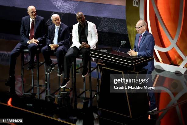 Naismith Memorial Basketball Hall of Fame Class of 2022 enshrinee George Karl speaks as Bobby Jones, Roy Williams and Gary Payton look on during the...