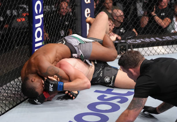 Jailton Almeida of Brazil secures a submission against Anton Turkalj of Sweden in a 220-pound catchweight fight during the UFC 279 event at T-Mobile...
