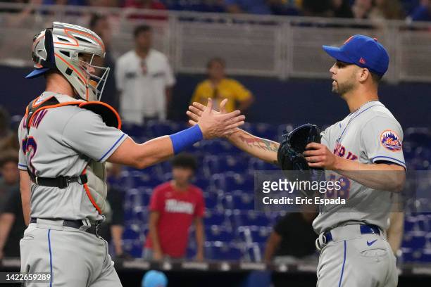 Alex Claudio of the New York Mets shakes hands with James McCann after defeating the Miami Marlins at loanDepot park on September 10, 2022 in Miami,...