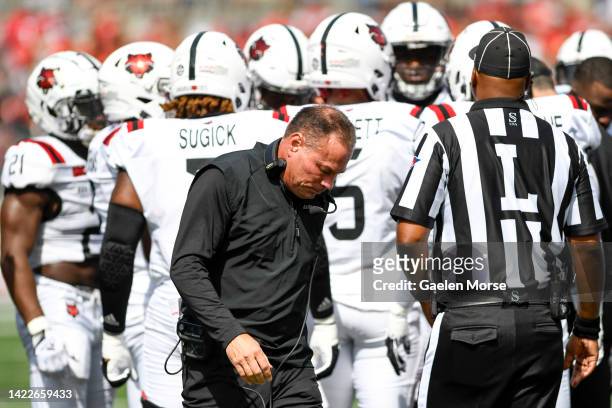 Coach Butch Jones of the Arkansas State Red Wolves walks away from a timeout huddle during the first quarter against the Ohio State Buckeyes at Ohio...