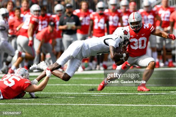 Linebacker Tommy Eichenberg of the Ohio State Buckeyes tackles quarterback James Blackman of the Arkansas State Red Wolves at Ohio Stadium on...