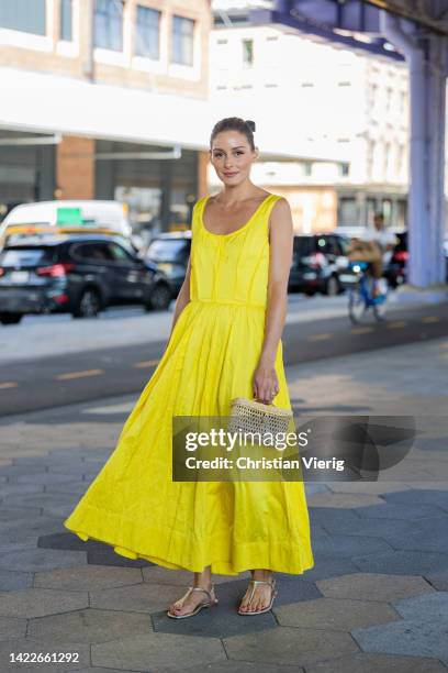 Olivia Palermo wearing yellow dress, bag outside Jason Wu on September 10, 2022 in New York City.