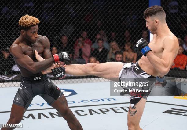 Julian Erosa kicks Hakeem Dawodu of Canada in a featherweight fight during the UFC 279 event at T-Mobile Arena on September 10, 2022 in Las Vegas,...