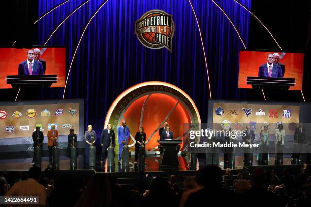 Naismith Memorial Basketball Hall of Fame Class of 2022 enshrinees stand onstage as Jerry Colangelo speaks during the 2022 Basketball Hall of Fame...