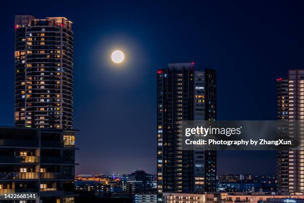 high rise residential buildings in toyosu aerial at night. - luna piena foto e immagini stock