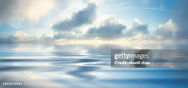 sky reflecting in lake - water surface stock-fotos und bilder