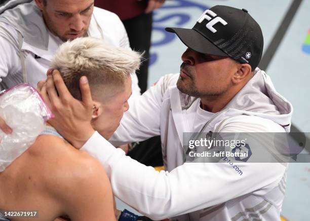 Macy Chiasson receives instruction from coach Sayif Saud in her corner between rounds of her 140-pound catchweight fight against Irene Aldana of...