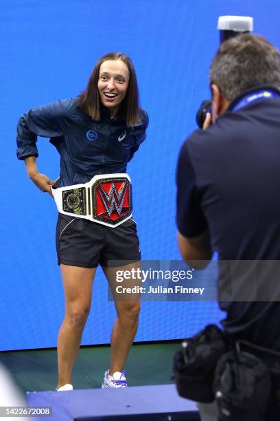 Iga Swiatek of Poland poses with a championship belt after defeating Ons Jabeur of Tunisia after their Women’s Singles Final match on Day Thirteen of...