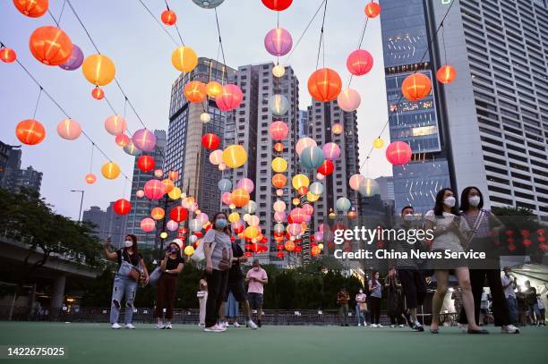 Tourists walk under festive lanterns at Victoria Park during the Mid-Autumn Festival on September 10, 2022 in Hong Kong, China.